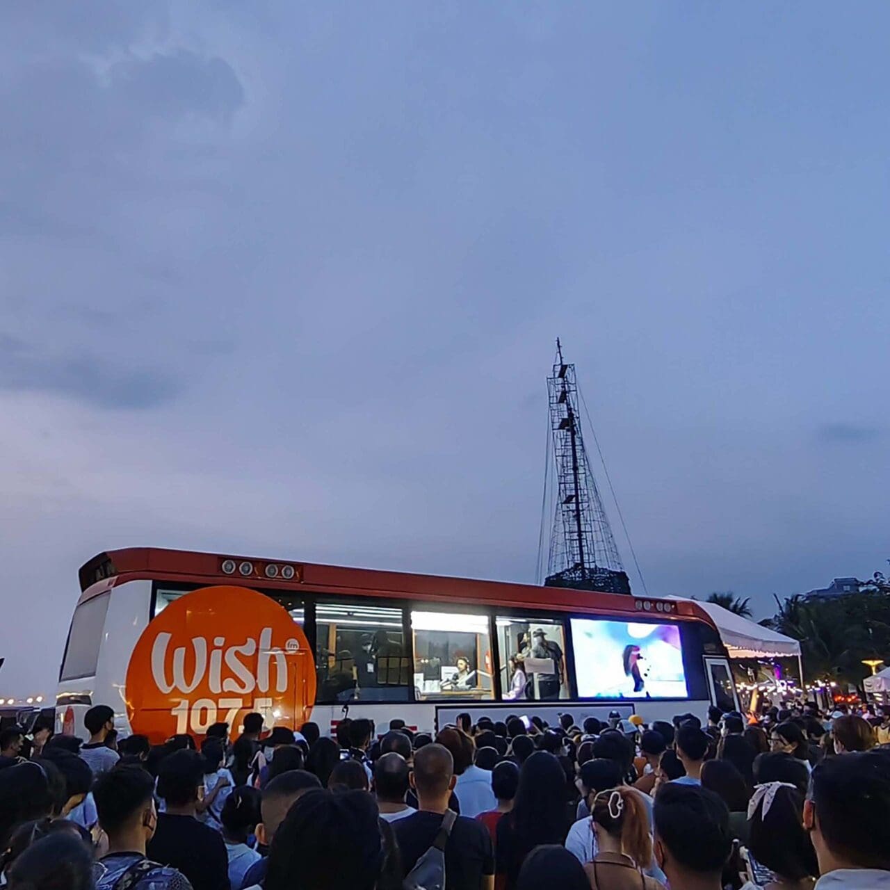 wish 107.5 bus in sm moa with a crowd outside it