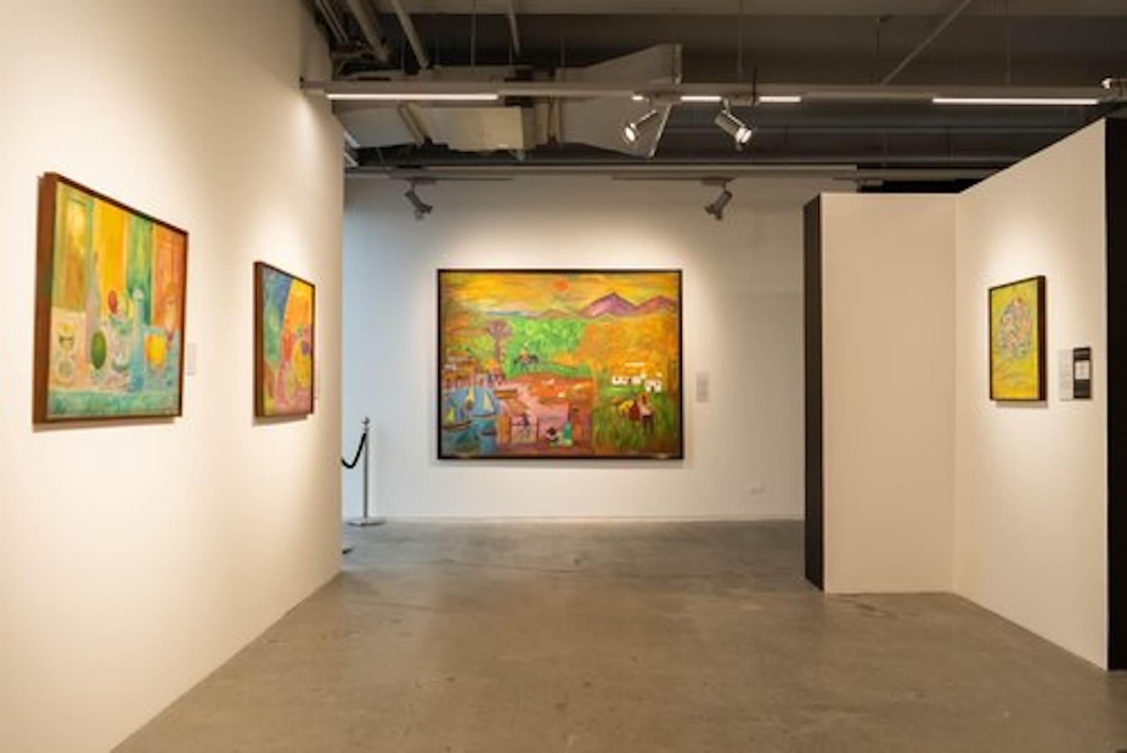 A gallery space with colorful paintings