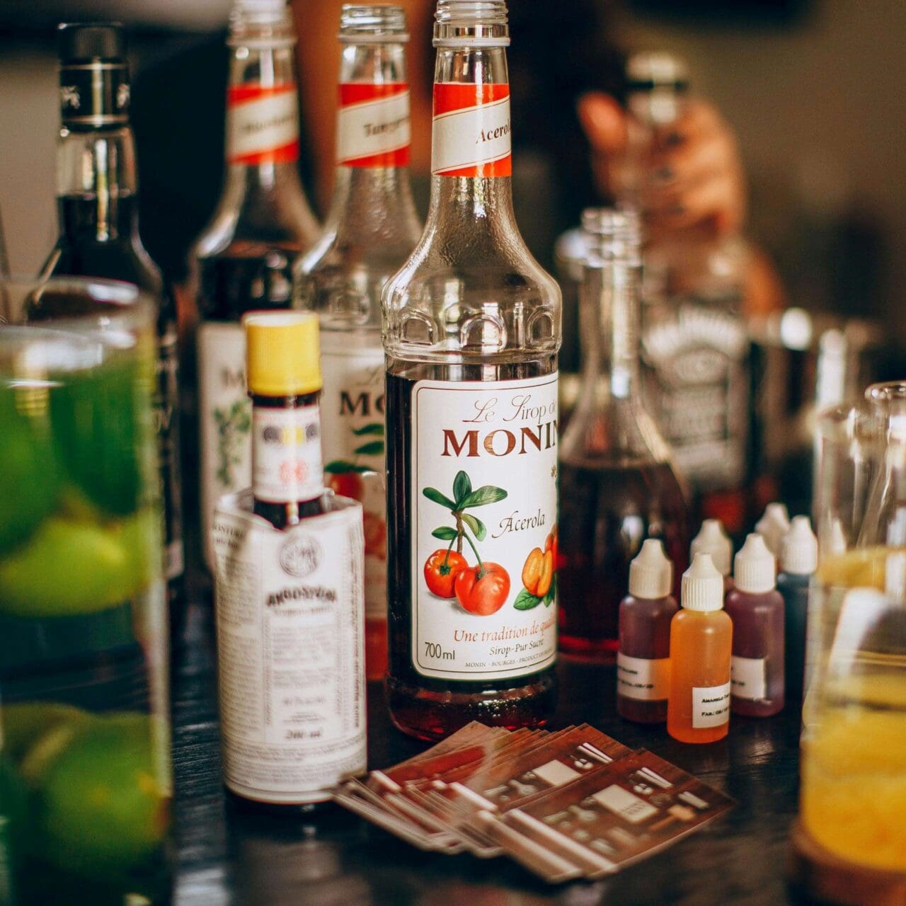 two set of hands holding cocktails alcoholic beverages