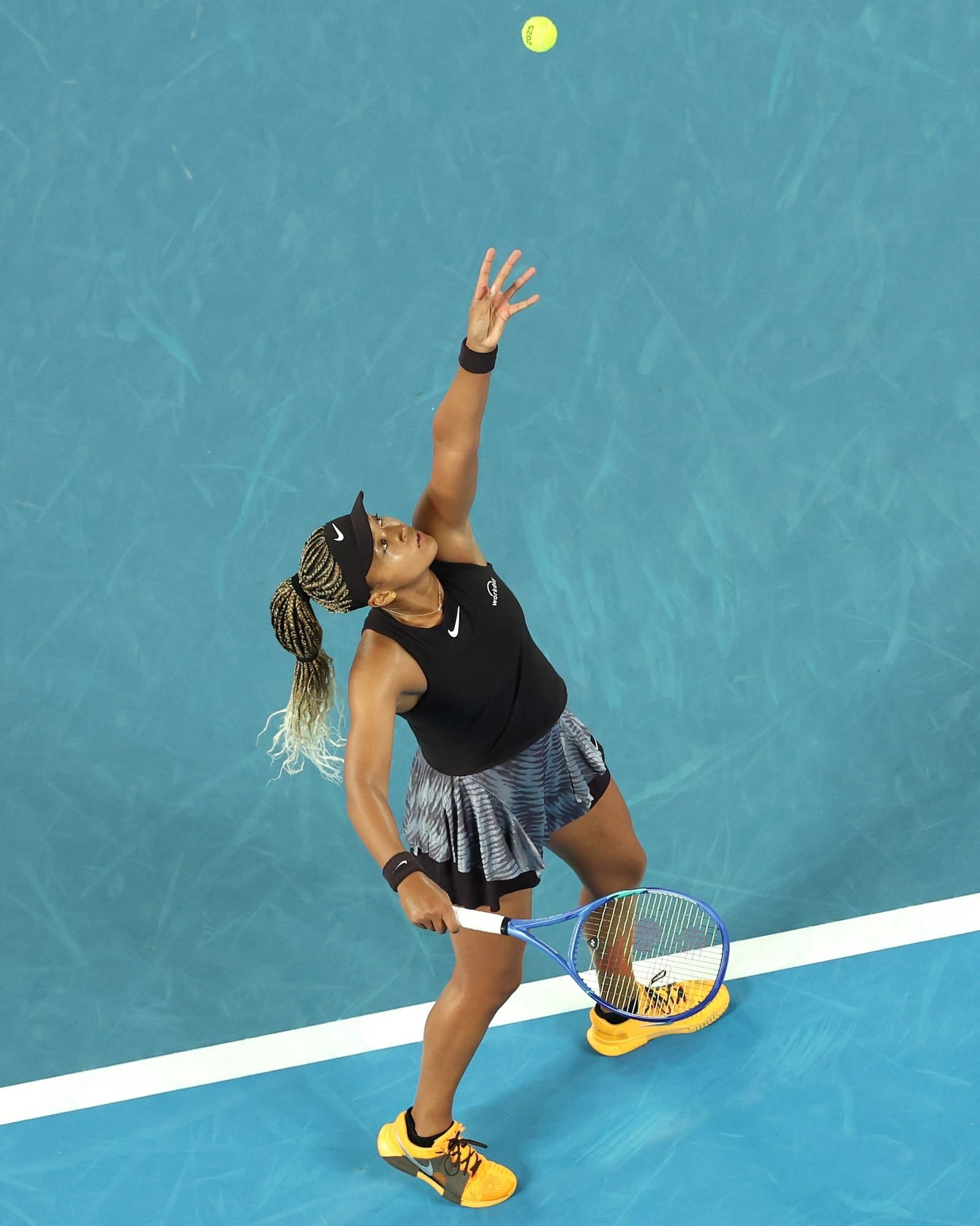 tennis player naomi osaka serving during the first round against carolina garcia at the 2025 australian open