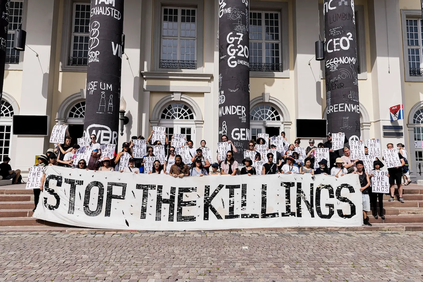Respond and Break the Silence Against the Killings (RESBAK), banner activation, Friedrichsplatz, Kassel, June 18, 2022 by Kiri Dalena documenta