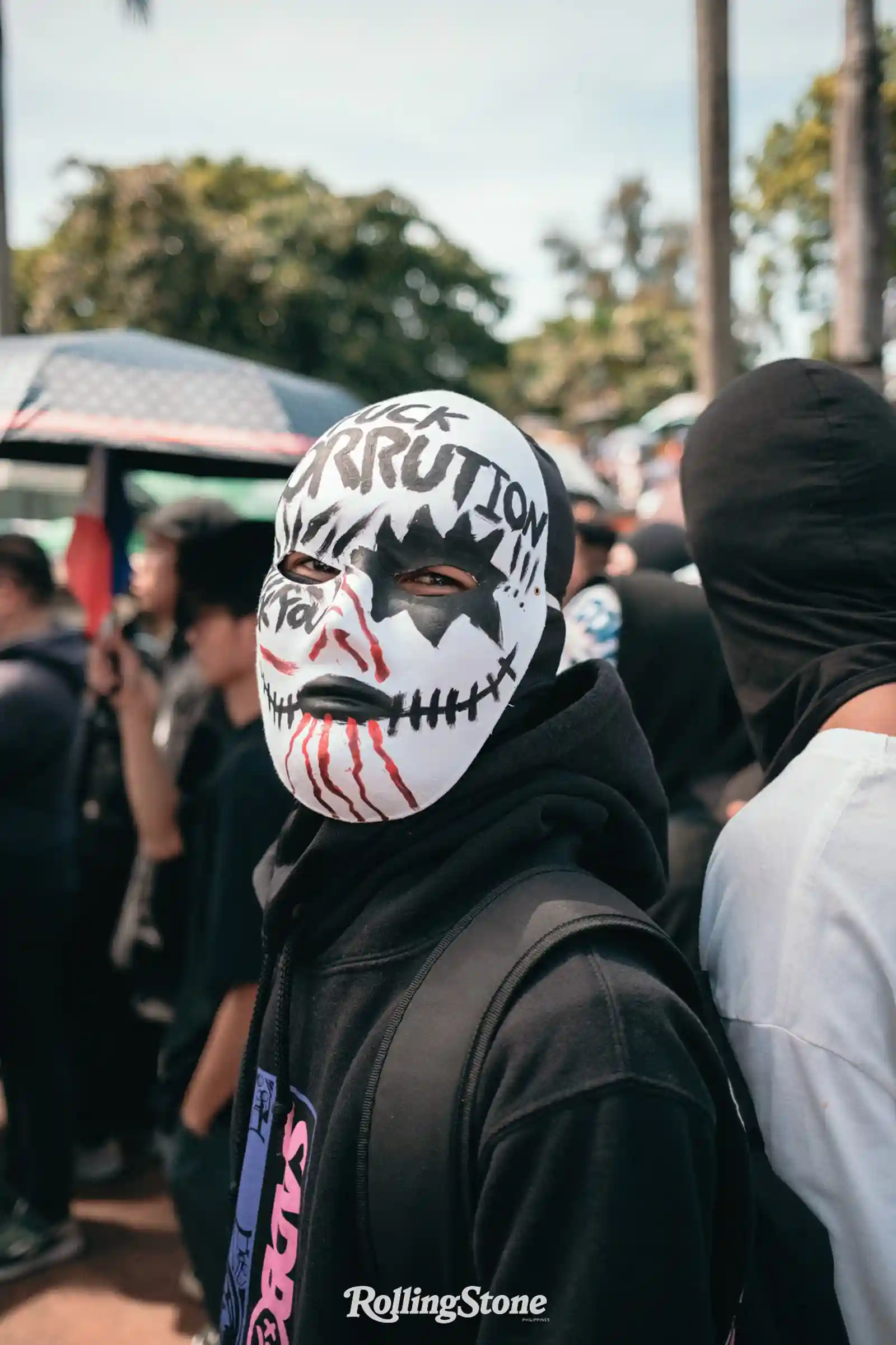 protester wearing anti corruption mask