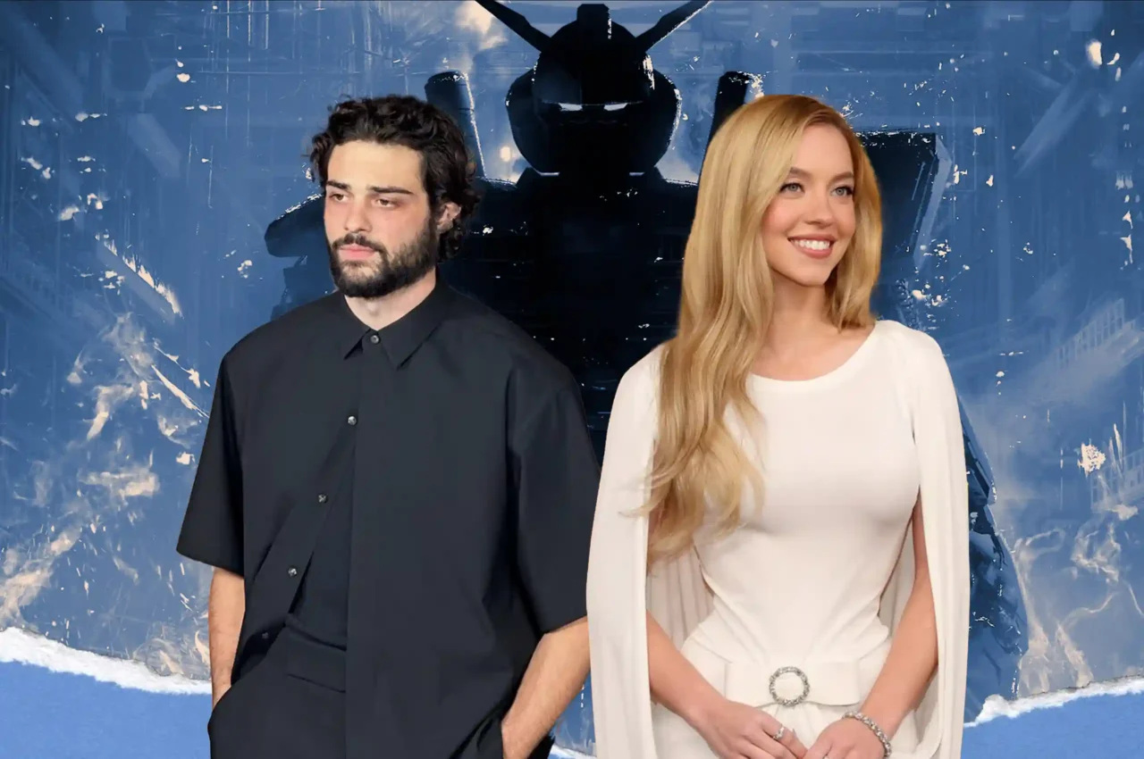 Man with dark hair and beard in a black shirt standing next to a smiling blonde woman in a white dress against a blue abstract snowy backdrop.