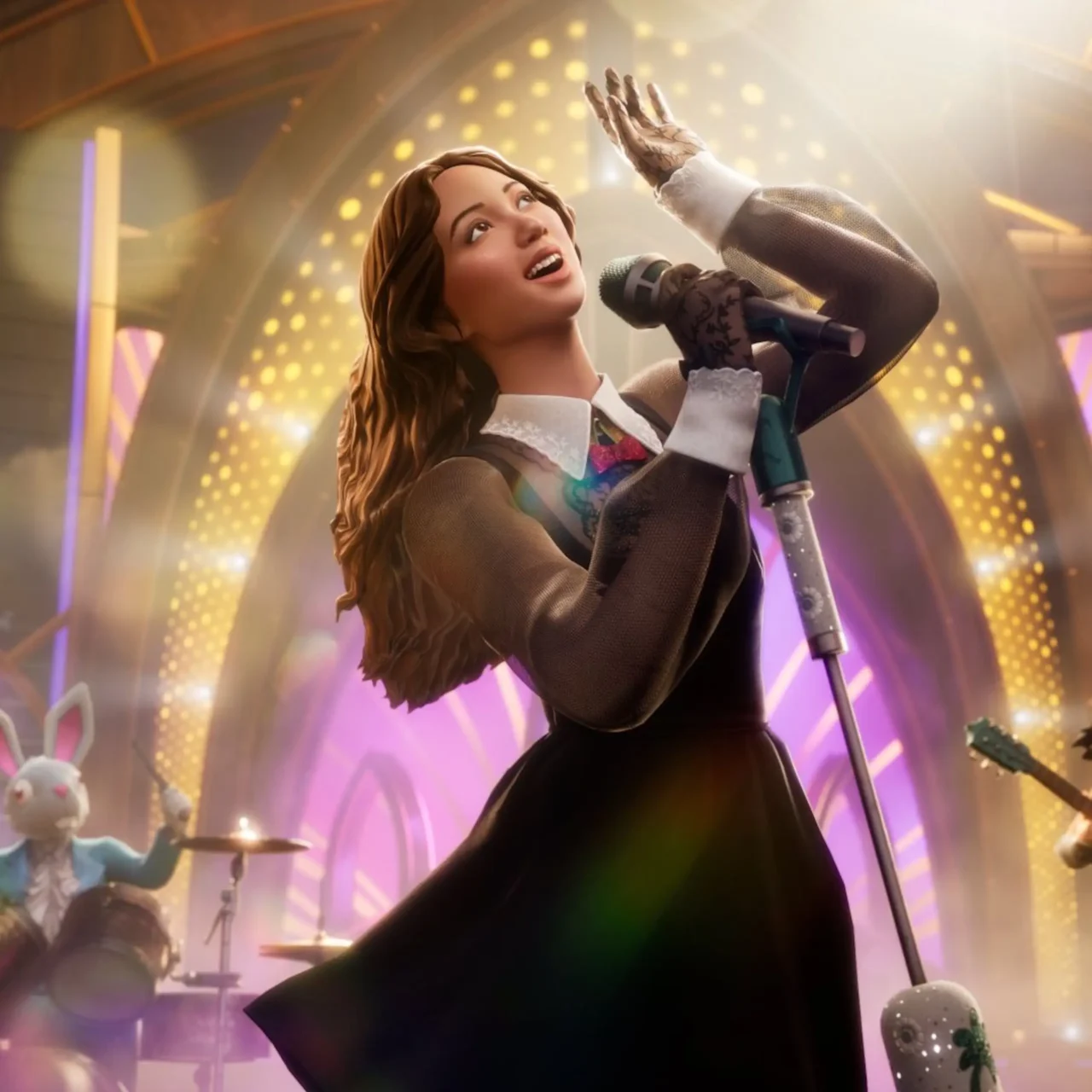 Female singer on stage singing into a microphone, hand raised, with a guitarist and drummer in a bunny costume in the background under bright stage lights.