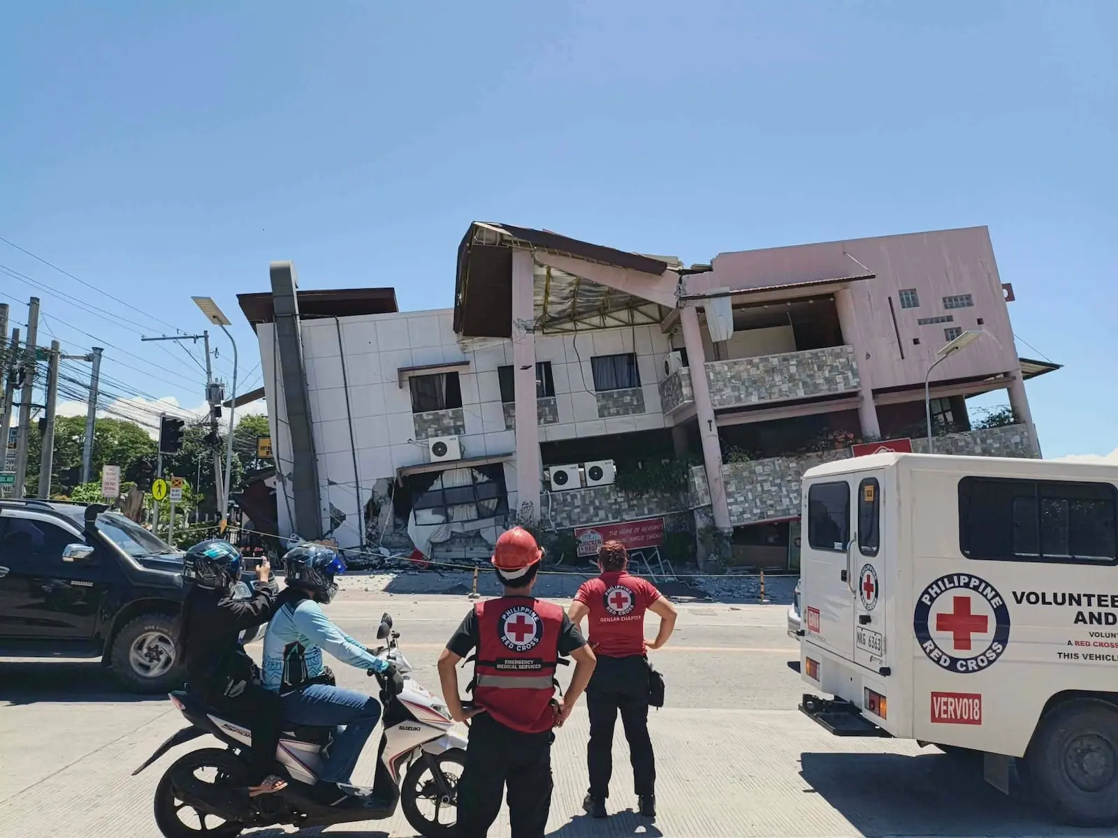 philippine red cross workers outside collapsed building after earthquake in general santos city