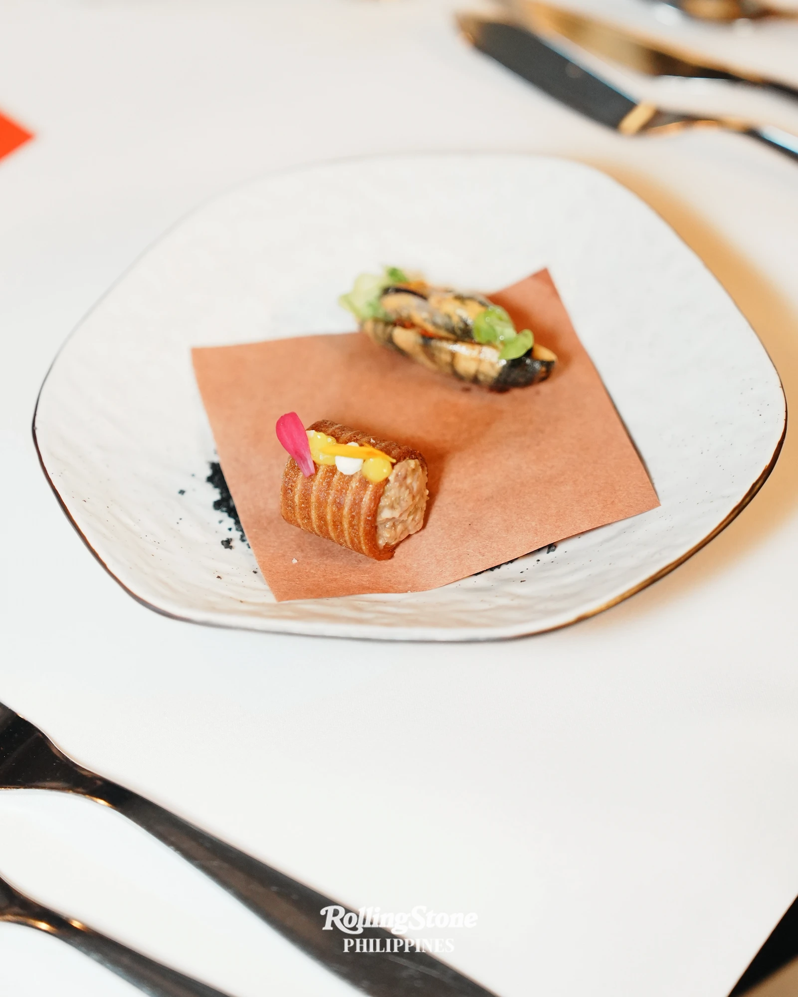 A duo of mussel escabeche and squid ink beef tartare. Photo by Kieran Punay